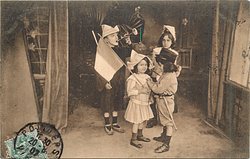four children in room, boy on left faces right blowing trumpet, boy & girl at front face each other, taller girl behind holds book
