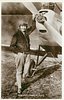 Image 1 - in flying gear, holding on to prop near its axle, right hand in pocket
