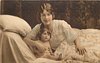 Image 1 - mother in bed with child, mother right & back, her right hand in front of childs chest, child sitting close to mothers right chest