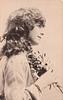 Image 1 - girl right profile, holds flowers to chest, looks & faces right