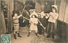 Image 1 - four children in room, boy on left faces right with sword in air boy & 2 girls face front pointing weapons at him