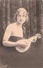 Image 3 - pretty girl with long hair in off shoulder dress faces partly right with mandolin held in before her, looks front & up, braid over her left shoulder