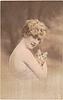 Image 1 - girl faces right looking front holds kitten in right arm, left hand not visible