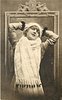 Image 1 - pretty girl with ermine fur & cap posed in front of framed mirror, she faces front looks up, hands behind head