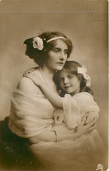 girl holds onto mothers shoulder